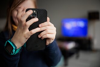 Vaikas su mobiliuoju telefonu Vaikas su mobiliuoju telefonu